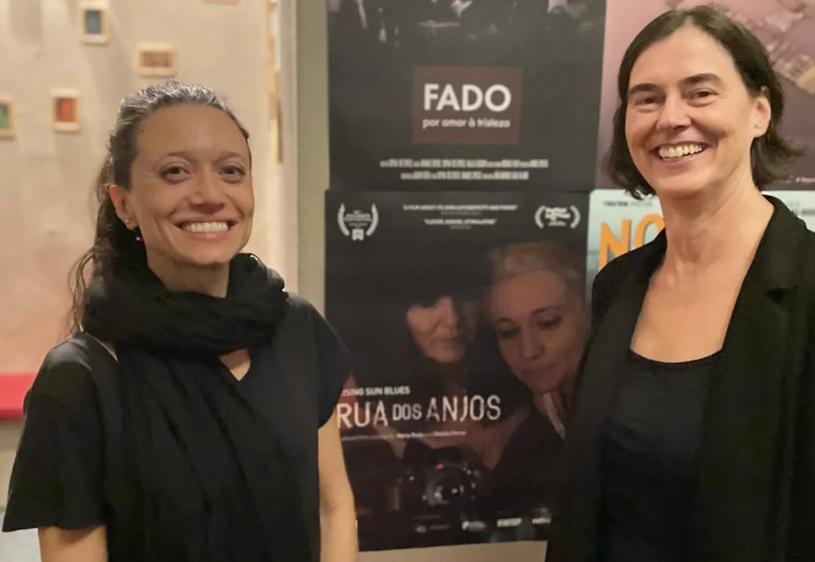Guests by the festival posters, including Rua dos Anjos