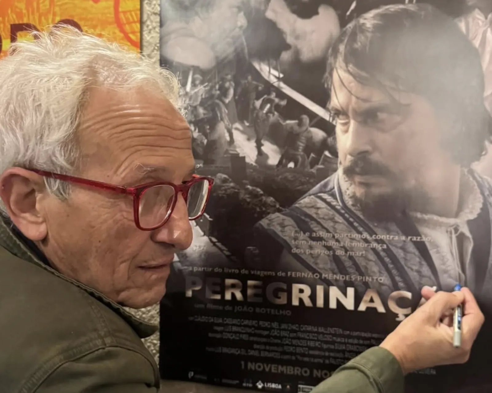 João Botelho signs the poster for his epic Peregrinação
